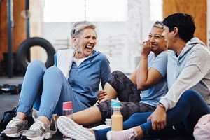 Group of friends smiling while talking at gym