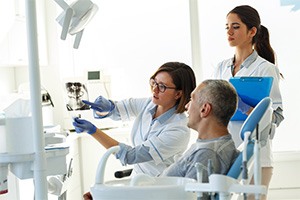 Patient in Toronto talking to dentist about dental implants