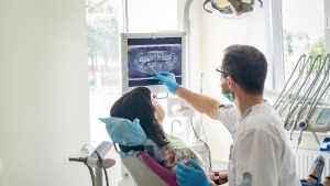 A dentist showing a patient their X-rays